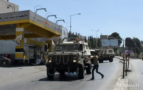 Palestinian youths throw at Israeli military patrols during a military operation at Ein Beit Alma' refugee camp near the West Bank city of Nablus, on Sep. 03, 2014. Photo by Nedal Eshtayah