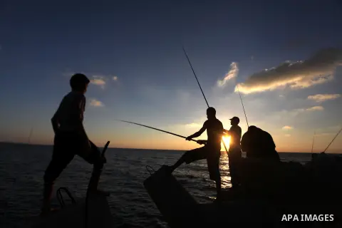 Palestinian fishermen fishing during sunset at Gaza's seaport in Gaza City on Sep. 03 2014. Israel and Hamas accepted an Egyptian proposal for a long-term ceasefire in war-torn Gaza. Restrictions imposed on Gaza fisherme...