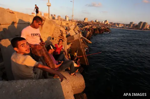 Palestinian fishermen fishing during sunset at Gaza's seaport in Gaza City on Sep. 03 2014. Israel and Hamas accepted an Egyptian proposal for a long-term ceasefire in war-torn Gaza. Restrictions imposed on Gaza fisherme...
