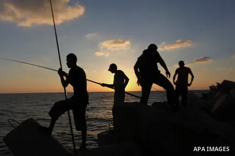 Palestinian fishermen fishing during sunset at Gaza's seaport in Gaza City on Sep. 03 2014. Israel and Hamas accepted an Egyptian proposal for a long-term ceasefire in war-torn Gaza. Restrictions imposed on Gaza fisherme...