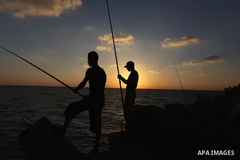 Palestinian fishermen fishing during sunset at Gaza's seaport in Gaza City on Sep. 03 2014. Israel and Hamas accepted an Egyptian proposal for a long-term ceasefire in war-torn Gaza. Restrictions imposed on Gaza fisherme...