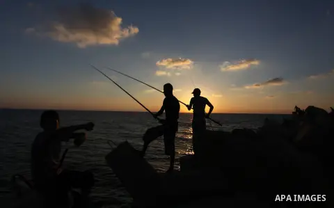 Palestinian fishermen fishing during sunset at Gaza's seaport in Gaza City on Sep. 03 2014. Israel and Hamas accepted an Egyptian proposal for a long-term ceasefire in war-torn Gaza. Restrictions imposed on Gaza fisherme...