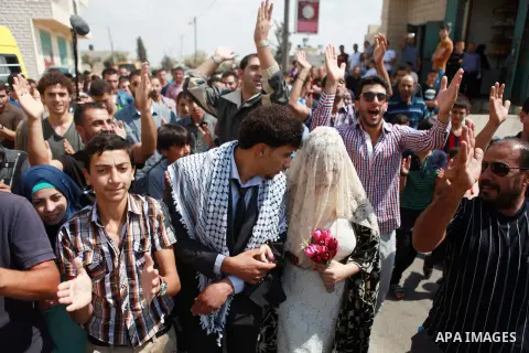 Palestinians take part in a representation wedding ceremony to refused what they say is land confiscation for Jewish settlements village of Qaryout, near the West Bank City of Nablus on Sep. 05, 2014. Photo by Shadi Hate...
