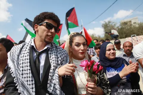 Palestinians take part in a representation wedding ceremony to refused what they say is land confiscation for Jewish settlements village of Qaryout, near the West Bank City of Nablus on Sep. 05, 2014. Photo by Shadi Hate...