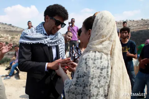 Palestinians take part in a representation wedding ceremony to refused what they say is land confiscation for Jewish settlements village of Qaryout, near the West Bank City of Nablus on Sep. 05, 2014. Photo by Shadi Hate...