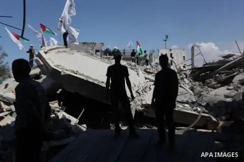 Palestinians hold national flags during a protest in the Shejaia neighbourhood, east of Gaza City. September 6, 2014. Calm returned to the coastal enclave in a August 26 ceasefire, and Gazans were gradually starting to r...
