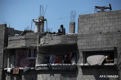 Palestinians gather around the the remains of their house that witnesses said were destroyed in an Israeli offensive, after a ceasefire was declared in the Shejaia neighbourhood, east of Gaza City. September 6, 2014. Cal...