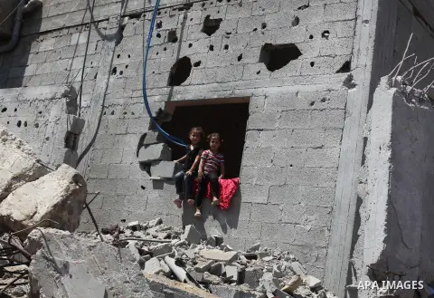 Palestinian children sit on the rubble of their house that witnesses said were destroyed in an Israeli offensive, after a ceasefire was declared in the Shejaia neighbourhood, east of Gaza City. September 6, 2014. Calm re...