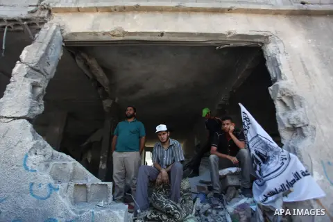 Palestinians gather around the the remains of their house that witnesses said were destroyed in an Israeli offensive, after a ceasefire was declared in the Shejaia neighbourhood, east of Gaza City. September 6, 2014. Cal...