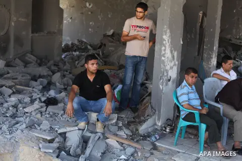 Palestinians gather around the the remains of their house that witnesses said were destroyed in an Israeli offensive, after a ceasefire was declared in the Shejaia neighbourhood, east of Gaza City. September 6, 2014. Cal...