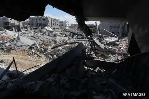 Palestinians gather around the the remains of their house that witnesses said were destroyed in an Israeli offensive, after a ceasefire was declared in the Shejaia neighbourhood, east of Gaza City. September 6, 2014. Cal...