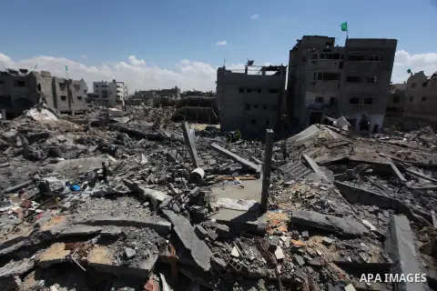 Palestinians gather around the the remains of their house that witnesses said were destroyed in an Israeli offensive, after a ceasefire was declared in the Shejaia neighbourhood, east of Gaza City. September 6, 2014. Cal...