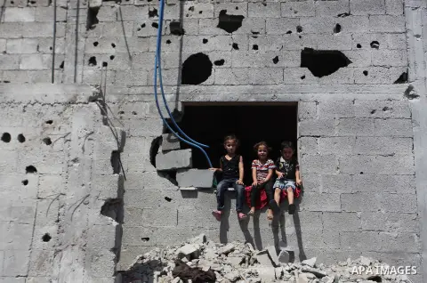 Palestinian children sit on the rubble of their house that witnesses said were destroyed in an Israeli offensive, after a ceasefire was declared in the Shejaia neighbourhood, east of Gaza City. September 6, 2014. Calm re...