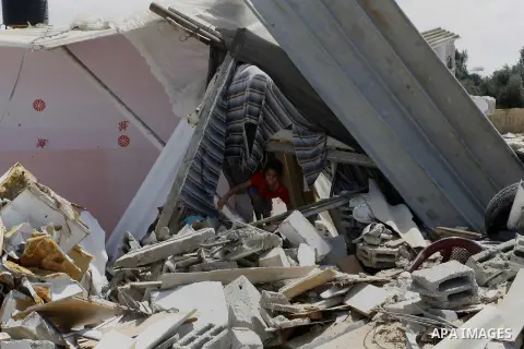 A Palestinian girl walks on the rubble of her famiy's house which destroyed during fighting between Hamas militants and Israel in east of Rafah in southern Gaza strip on September 07, 2014. Calm returned to the coastal e...