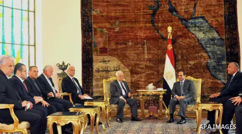 A handout photo made available by the Egyptian Presidency shows Egyptian President Abdel Fattah el-Sissi, meets Palestinian President Mahmoud Abbas, center and Saeb Erekat, chief Palestinian negotiator at the presidentia...