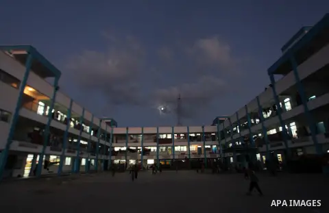 Palestinians watch children play a UN school in Beit Hanoun in northern Gaza strip on Sep. 07, 2014. Calm returned to the coastal enclave in a August 26 ceasefire, and Gazans were gradually starting to rebuild their live...