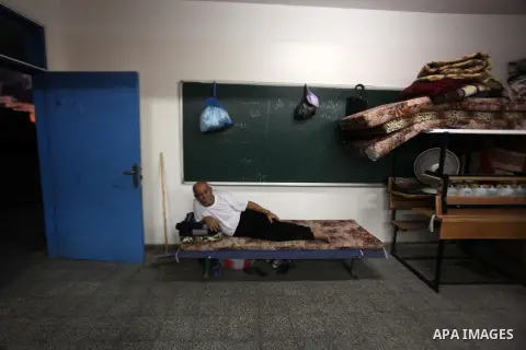 Palestinian displaced sit at a UN school in Beit Hanoun in northern Gaza strip on Sep. 07, 2014. Calm returned to the coastal enclave in a August 26 ceasefire, and Gazans were gradually starting to rebuild their lives af...