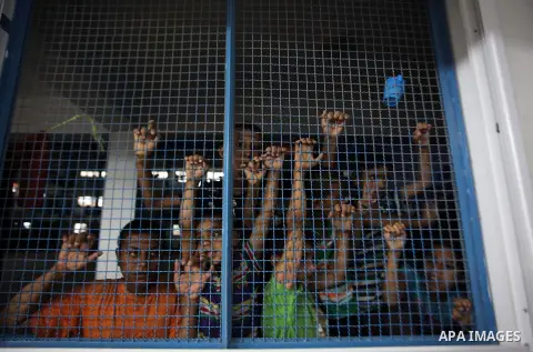Palestinians watch children play a UN school in Beit Hanoun in northern Gaza strip on Sep. 07, 2014. Calm returned to the coastal enclave in a August 26 ceasefire, and Gazans were gradually starting to rebuild their live...