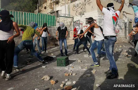 Palestinian protesters hurl stones during clashes with Israeli police in the East Jerusalem neighbourhood of Wadi Joz September 7, 2014. Palestinians rioted in Israeli-occupied East Jerusalem on Sunday after news that a...