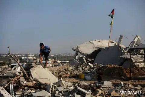A Palestinian boy walks past the rubble of his house which destroyed during fighting between Hamas militants and Israel in the center of Gaza strip on September 08, 2014. Calm returned to the coastal enclave in a August...