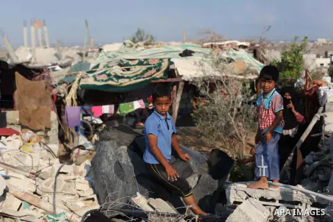Palestinians gather around the rubble of his house which destroyed during fighting between Hamas militants and Israel in the center of Gaza strip on September 08, 2014. Calm returned to the coastal enclave in a August 26...