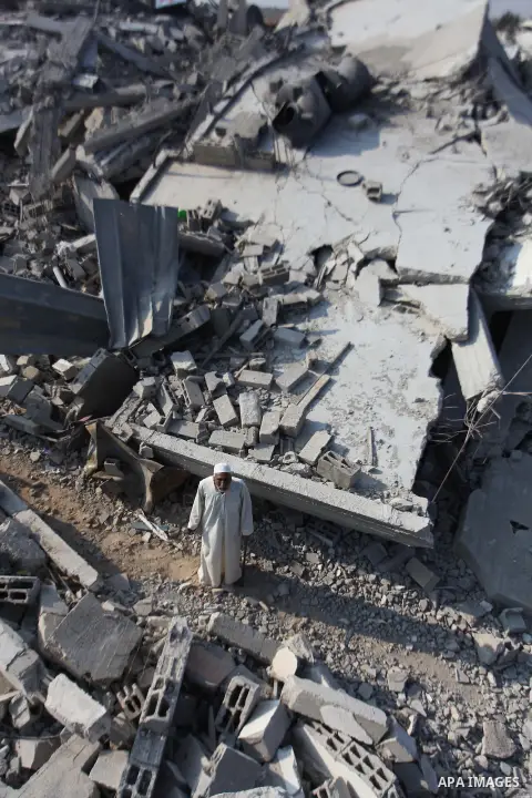 A Palestinian man stands on the rubble of her house which destroyed during fighting between Hamas militants and Israel in the center of Gaza strip on September 08, 2014. Calm returned to the coastal enclave in a August 2...