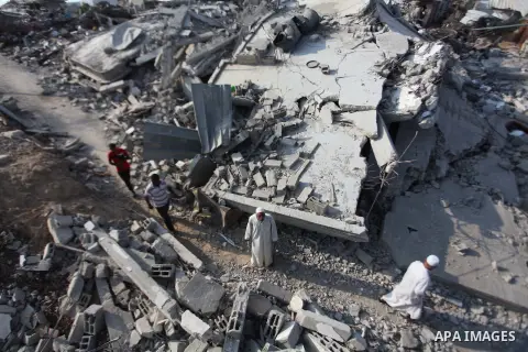 Palestinians gather around the rubble of his house which destroyed during fighting between Hamas militants and Israel in the center of Gaza strip on September 08, 2014. Calm returned to the coastal enclave in a August 26...
