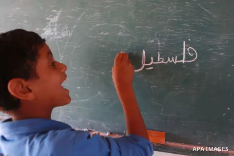 A Palestinian Bedouin Student learns at Arab Al-Ka'abneh school in Al-Mu'arrajat area near the West Bank city of Jericho, on Sep. 08, 2014. Dozens of Palestinian children in the ramshackle Bedouin community outside Jerus...