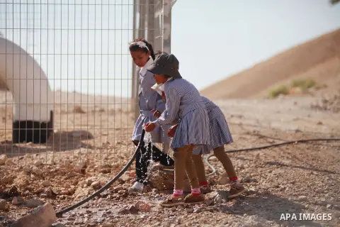 Palestinian Bedouin Students drink water at Arab Al-Ka'abneh school in Al-Mu'arrajat area near the West Bank city of Jericho, on Sep. 08, 2014. Dozens of Palestinian children in the ramshackle Bedouin community outside J...