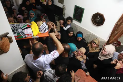 Palestinian Mourners carry the body of Palestinian Eissa al-Qotri, 22, during his funeral at al-Amari refugee camp, in the West Bank city of Ramallah, on Sep. 10, 2014. Al-Qatari was shot during clashes between young Pal...
