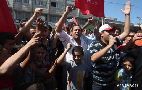 Palestinian supporters of the Democratic Front for the Liberation of Palestine (DFLP) strong chants during a military show in Gaza City September 11, 2014. An open-ended ceasefire between Israel and Hamas-led Gaza milita...