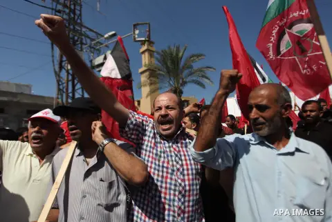 Palestinian supporters of the Democratic Front for the Liberation of Palestine (DFLP) strong chants during a military show in Gaza City September 11, 2014. An open-ended ceasefire between Israel and Hamas-led Gaza milita...