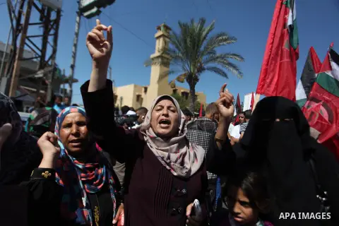 Palestinian supporters of the Democratic Front for the Liberation of Palestine (DFLP) strong chants during a military show in Gaza City September 11, 2014. An open-ended ceasefire between Israel and Hamas-led Gaza milita...