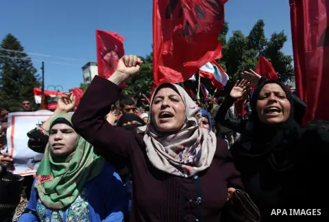Palestinian supporters of the Democratic Front for the Liberation of Palestine (DFLP) strong chants during a military show in Gaza City September 11, 2014. An open-ended ceasefire between Israel and Hamas-led Gaza milita...