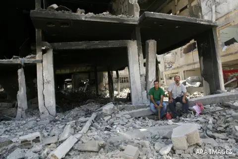 Palestinians set near destroyed houses in Khan Yunis in the southern Gaza Strip on September 11, 2014. Israel's deputy foreign minister,Tzahi Hanegbi , warned that Hamas was likely to resume "violence" if it feels it has...