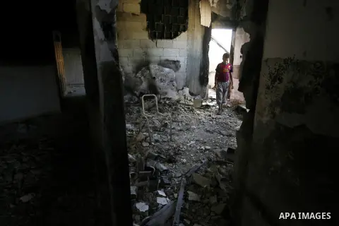 A Palestinian boy searches in a destroyed house in Khan Yunis in the southern Gaza Strip on September 11, 2014. Israel's deputy foreign minister,Tzahi Hanegbi , warned that Hamas was likely to resume "violence" if it fee...
