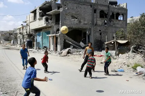 Palestinian children play near a destroyed house in Khan Yunis in the southern Gaza Strip on September 11, 2014. Israel's deputy foreign minister,Tzahi Hanegbi , warned that Hamas was likely to resume "violence" if it fe...