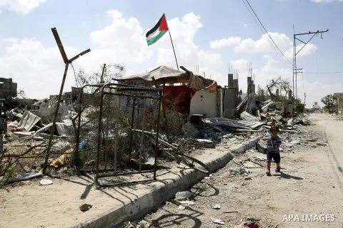 A Palestinian boy plays near a destroyed house in Khan Yunis in the southern Gaza Strip on September 11, 2014. Israel's deputy foreign minister,Tzahi Hanegbi , warned that Hamas was likely to resume "violence" if it feel...
