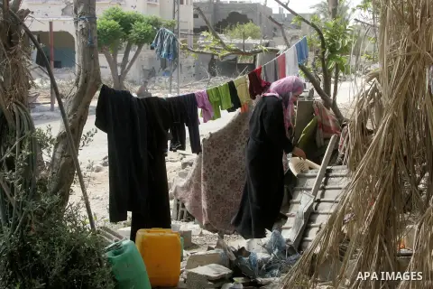 A Palestinian woman works near a destroyed house in Khan Yunis in the southern Gaza Strip on September 11, 2014. Israel's deputy foreign minister,Tzahi Hanegbi , warned that Hamas was likely to resume "violence" if it fe...