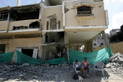 Palestinian children set near destroyed houses in Khan Yunis in the southern Gaza Strip on September 11, 2014. Israel's deputy foreign minister,Tzahi Hanegbi , warned that Hamas was likely to resume "violence" if it feel...