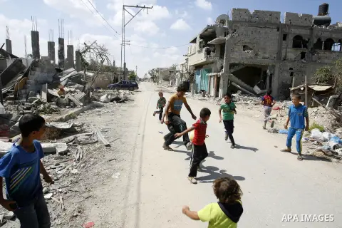 Palestinian children play near a destroyed house in Khan Yunis in the southern Gaza Strip on September 11, 2014. Israel's deputy foreign minister,Tzahi Hanegbi , warned that Hamas was likely to resume "violence" if it fe...