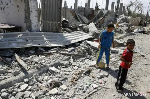 Palestinian children play near a destroyed house in Khan Yunis in the southern Gaza Strip on September 11, 2014. Israel's deputy foreign minister,Tzahi Hanegbi , warned that Hamas was likely to resume "violence" if it fe...
