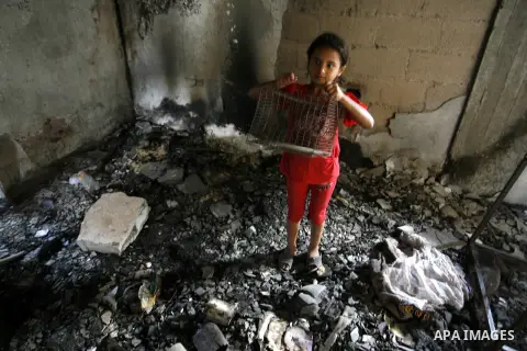 A Palestinian girl searches in a destroyed house in Khan Yunis in the southern Gaza Strip on September 11, 2014. Israel's deputy foreign minister,Tzahi Hanegbi , warned that Hamas was likely to resume "violence" if it fe...
