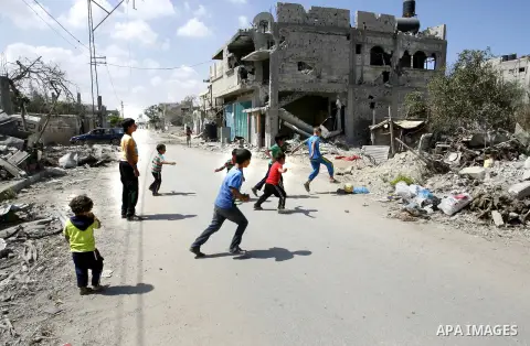 Palestinian children play near a destroyed house in Khan Yunis in the southern Gaza Strip on September 11, 2014. Israel's deputy foreign minister,Tzahi Hanegbi , warned that Hamas was likely to resume "violence" if it fe...