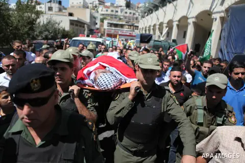 Palestinian security forces carry the body of Raed al-Jabari, 35, during his funeral in the West Bank city of Hebron, September 12, 2014. Al-Jabari died on Tuesday in Israel's Soroka Medical Center after Palestinian offi...