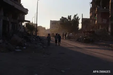 Palestinian students walk past houses that witnesses said were destroyed by the Israeli offensive, as they make their way to school on the first day of the new school year in the east of Gaza City September 14, 2014. An...