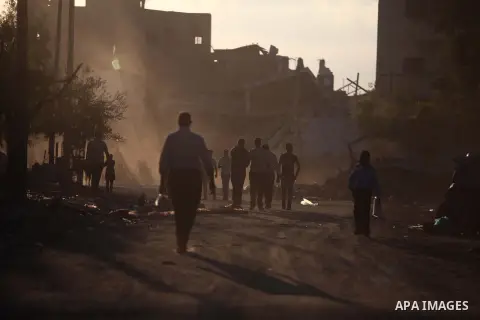 Palestinian students walk past houses that witnesses said were destroyed by the Israeli offensive, as they make their way to school on the first day of the new school year in the east of Gaza City September 14, 2014. An...