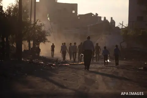 Palestinian students walk past houses that witnesses said were destroyed by the Israeli offensive, as they make their way to school on the first day of the new school year in the east of Gaza City September 14, 2014. An...