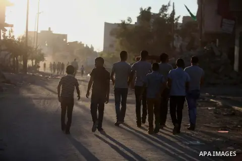 Palestinian students walk past houses that witnesses said were destroyed by the Israeli offensive, as they make their way to school on the first day of the new school year in the east of Gaza City September 14, 2014. An...