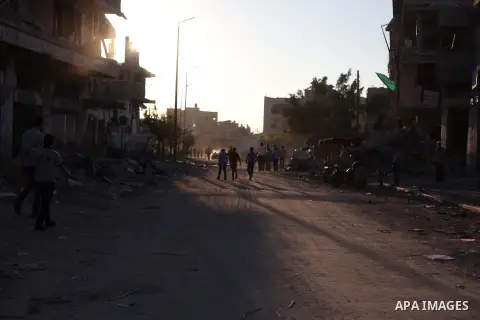 Palestinian students walk past houses that witnesses said were destroyed by the Israeli offensive, as they make their way to school on the first day of the new school year in the east of Gaza City September 14, 2014. An...